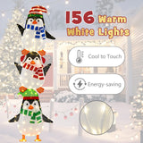 Decoración de pingüinos iluminados con luces blancas cálidas y sombreros bonitos