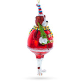 Dog in Fur Hat Holding Tree Glass Christmas Ornament