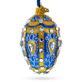 White Scrolls on Blue Glass Egg Ornament 4 Inches
